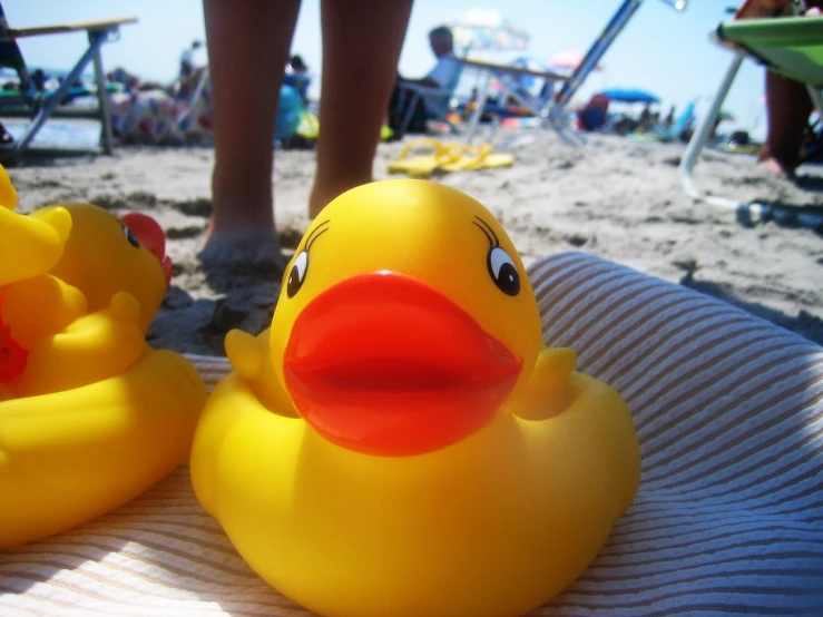 two rubber ducks are placed side by side on a towel