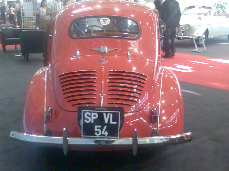 a red vehicle sitting on a show floor