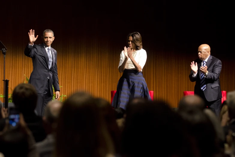 a couple of people that are standing in front of a microphone