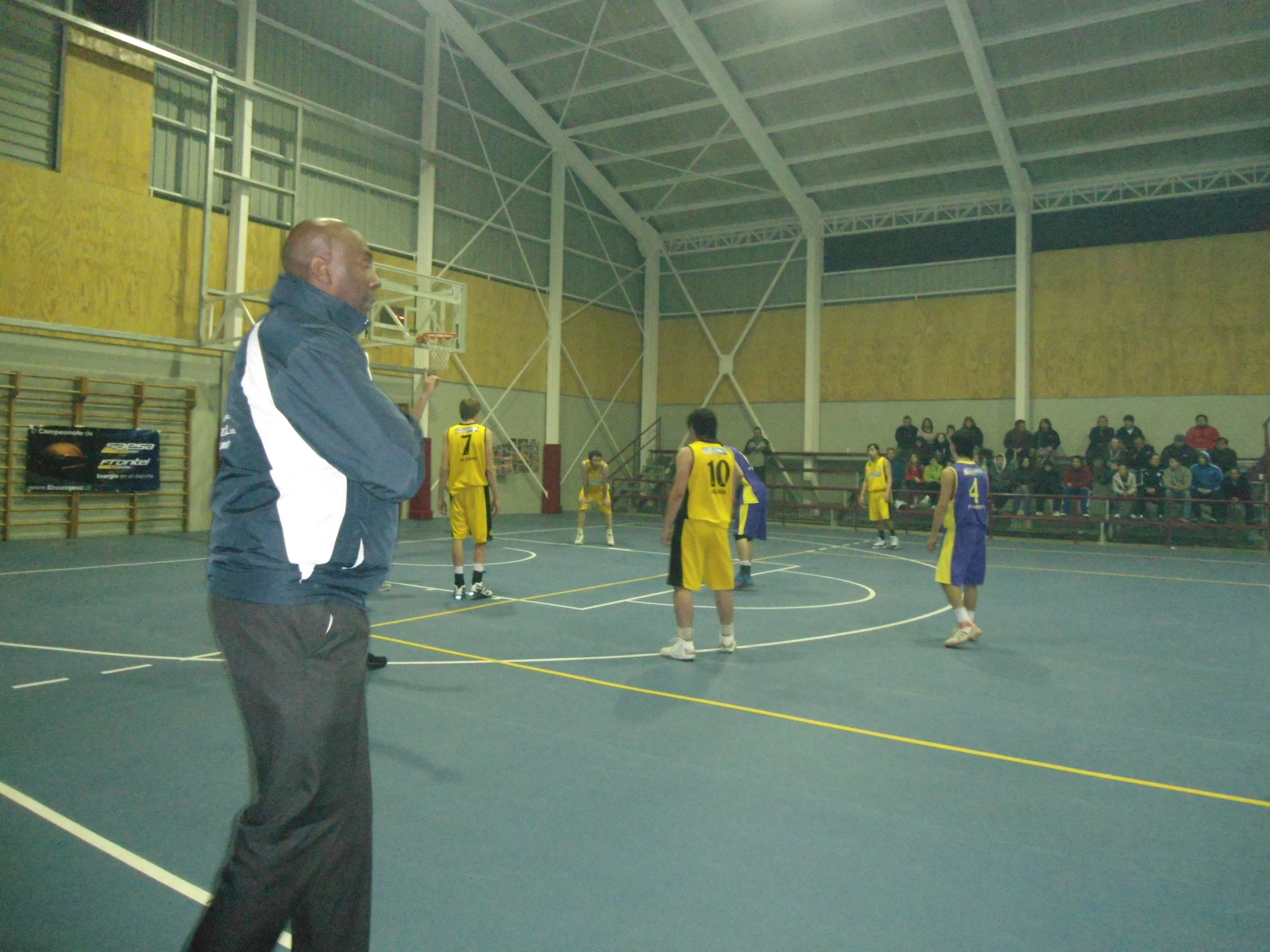 a basketball game being played on a hard surface court