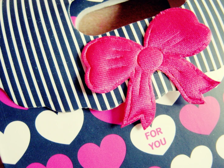 a valentine box with a ribbon bow tied into it