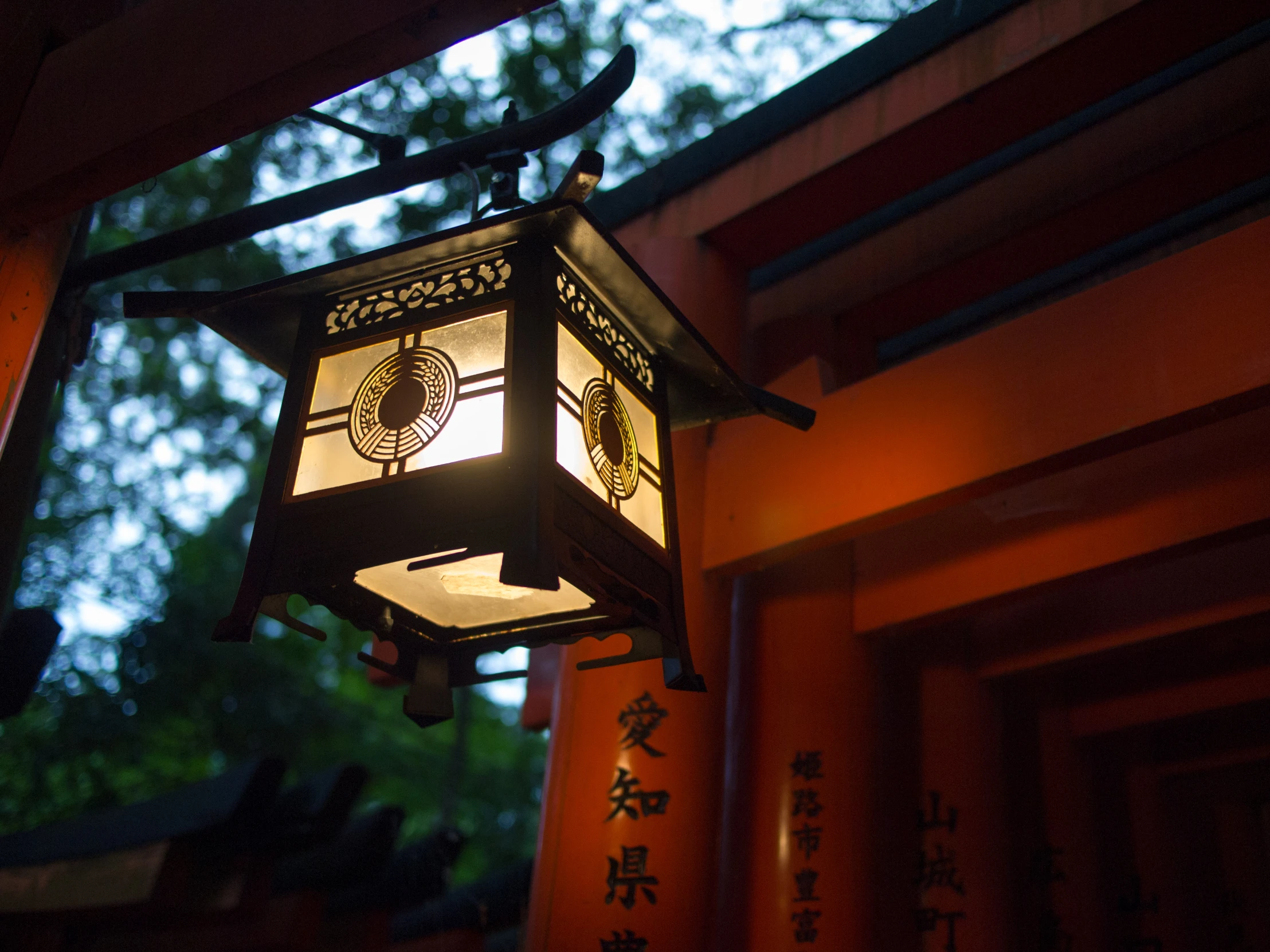 a lamp hanging from the side of a building