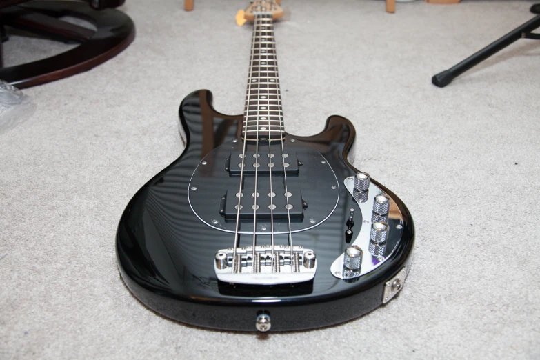 a guitar lying on the ground near other instruments