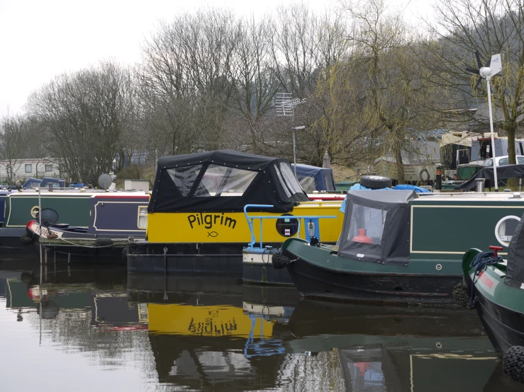 several boats are docked and parked on a body of water