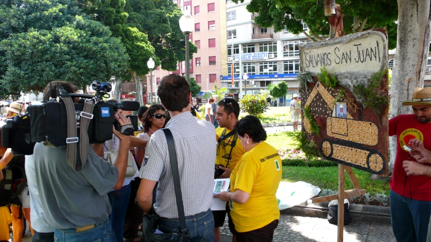 a group of people gathered around and taking pictures