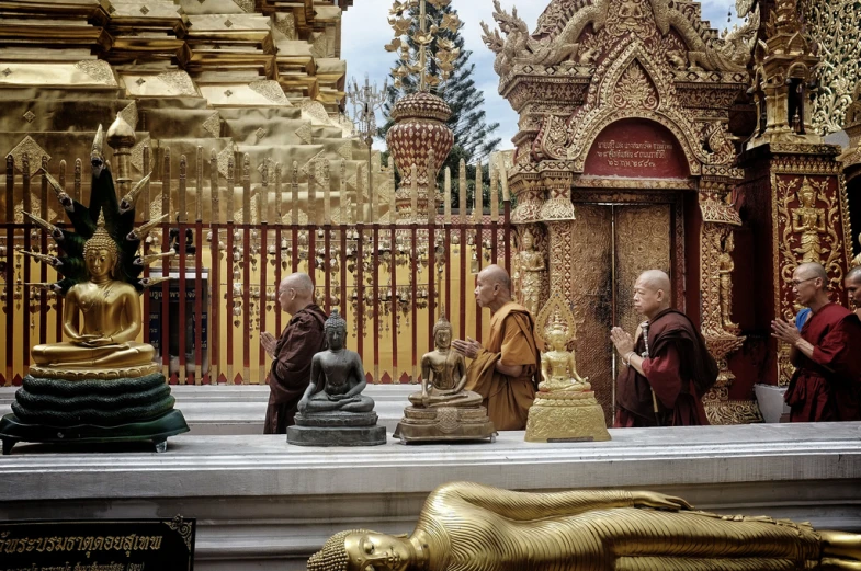 an assortment of buddhist statues inside a building