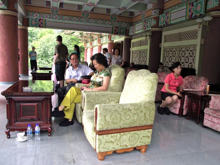 a group of people sitting around in a house