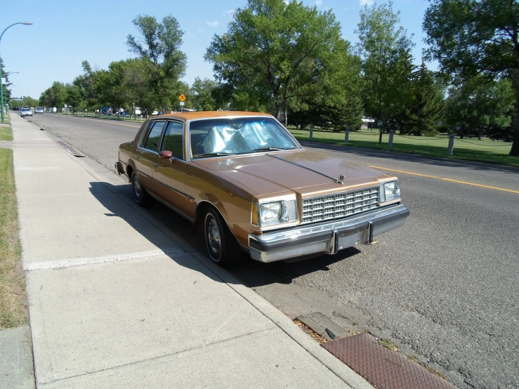 an old car parked in front of a curb