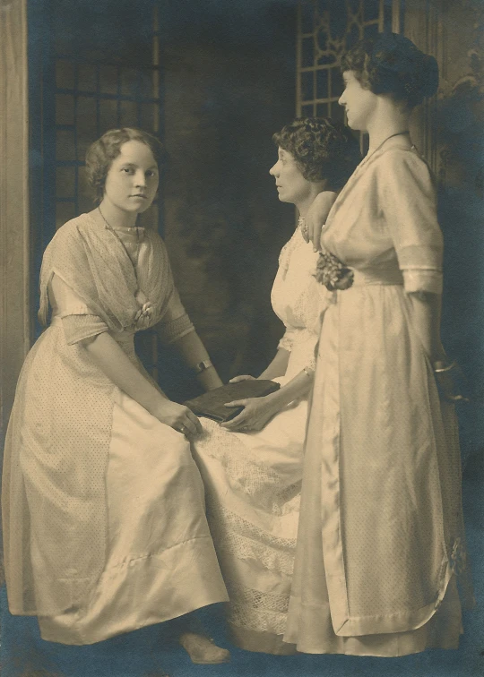 an old picture of a couple of women holding hands