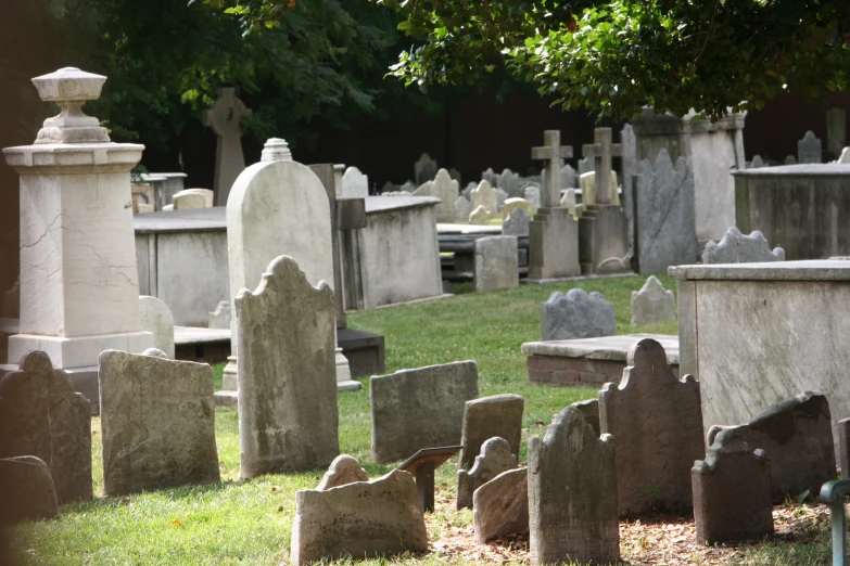 old cemetery full of stone headstones and trees