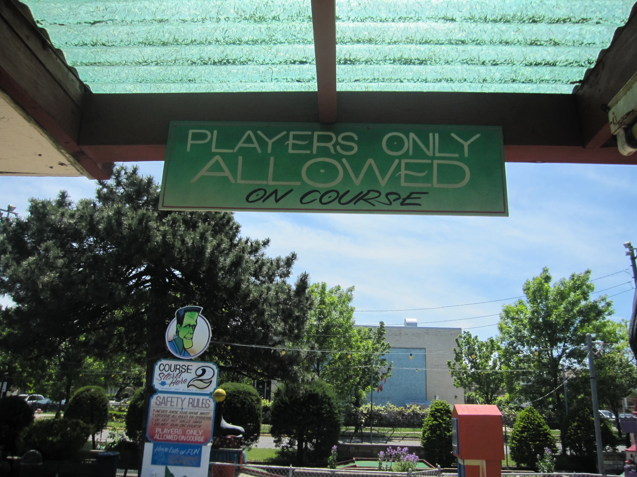 a sign is in front of a school with green writing