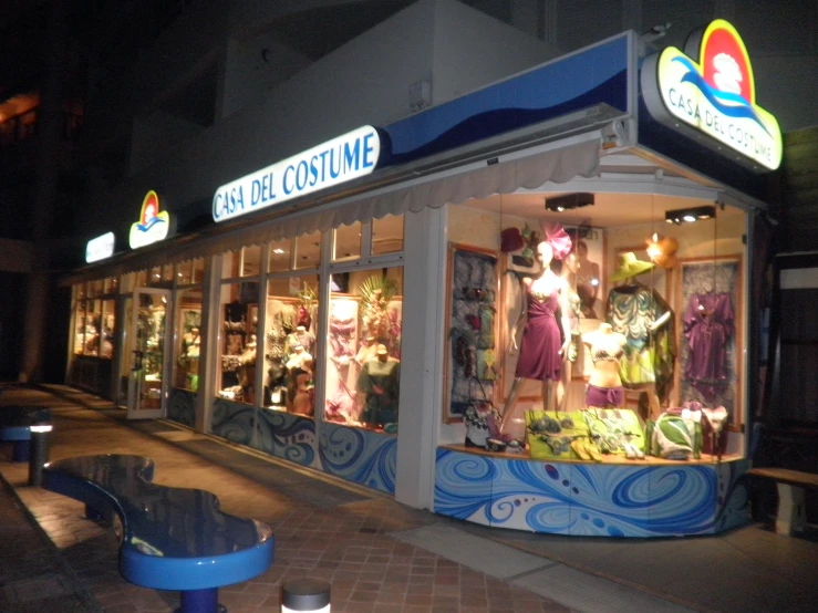 a store front with lots of lights and mannequins on display
