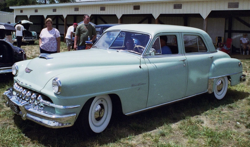 a classic car on display at an antique automobile show