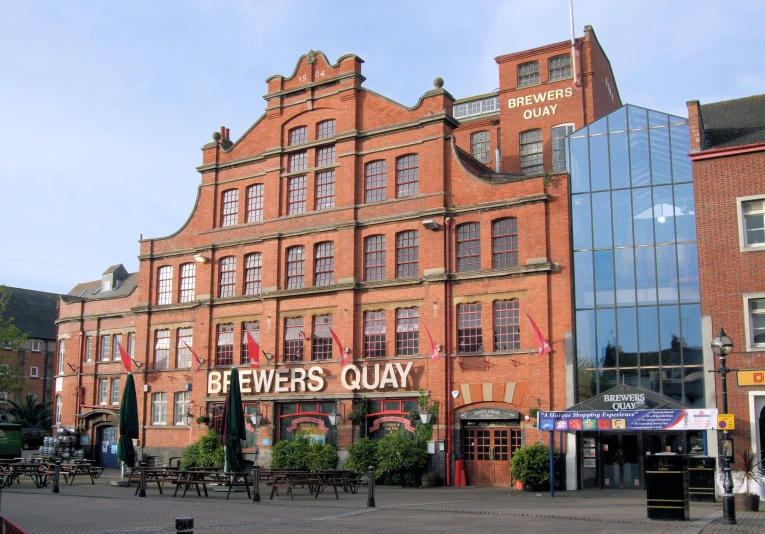 a big red building that says bers quay in front of it