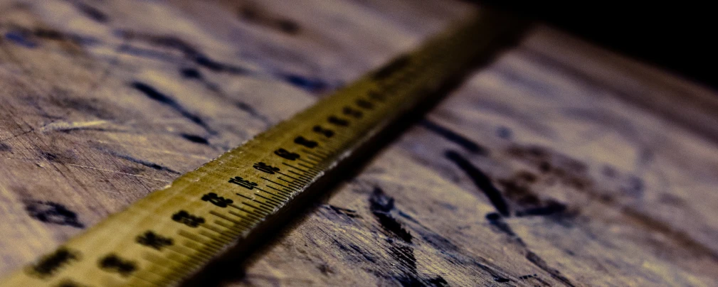 a measuring tape is on top of a wooden table