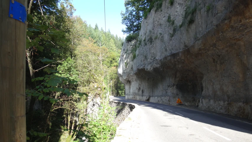 a road with no traffic on it going through a cliff side