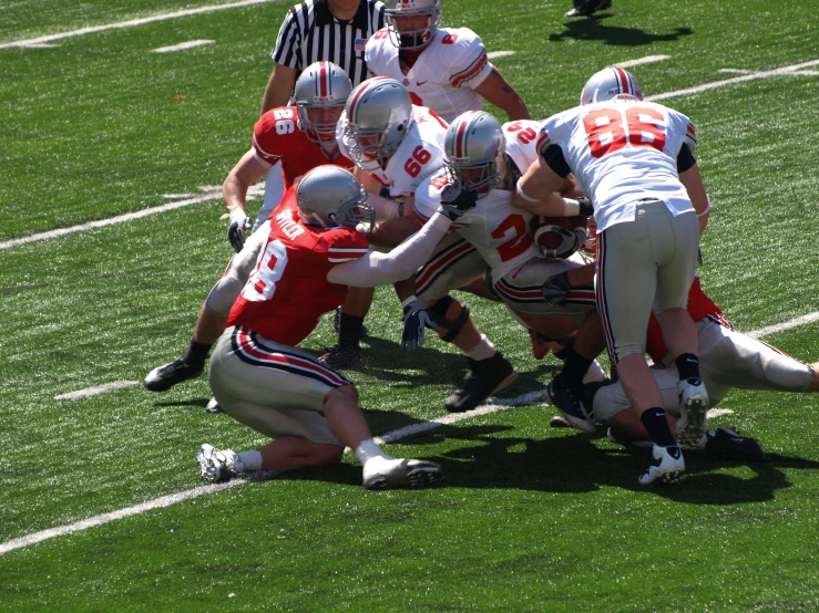 football players huddle together in preparation to battle for the ball