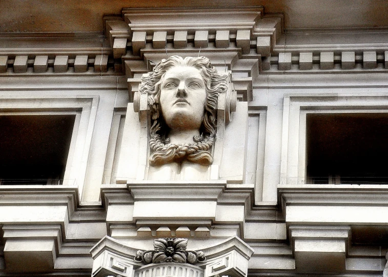 a bust of a man on a building front