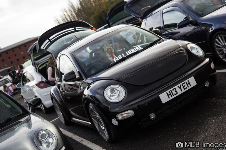 small cars with stickers and a group of people