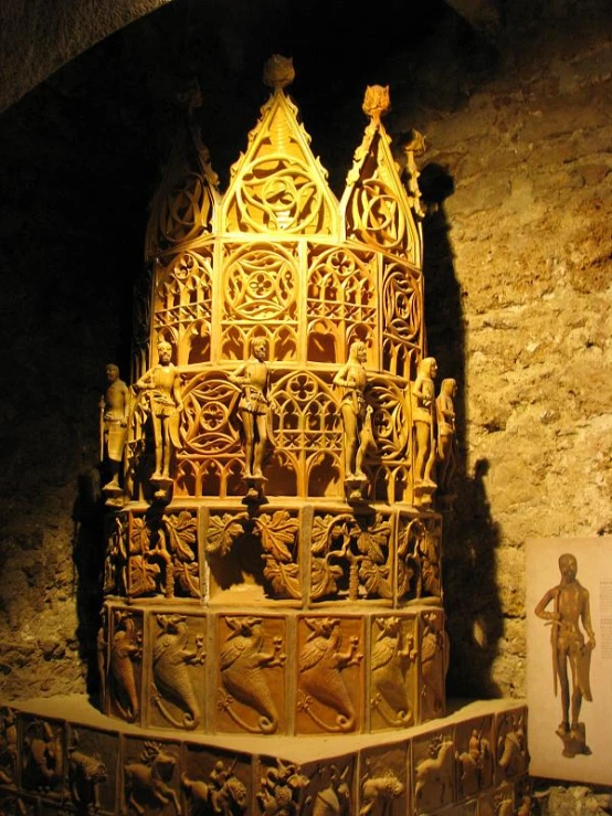 a very ornate carving in a room with a brick wall