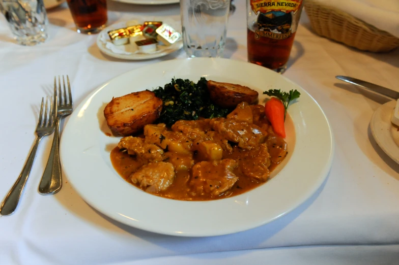 a meal of vegetables and meat in gravy with broccoli