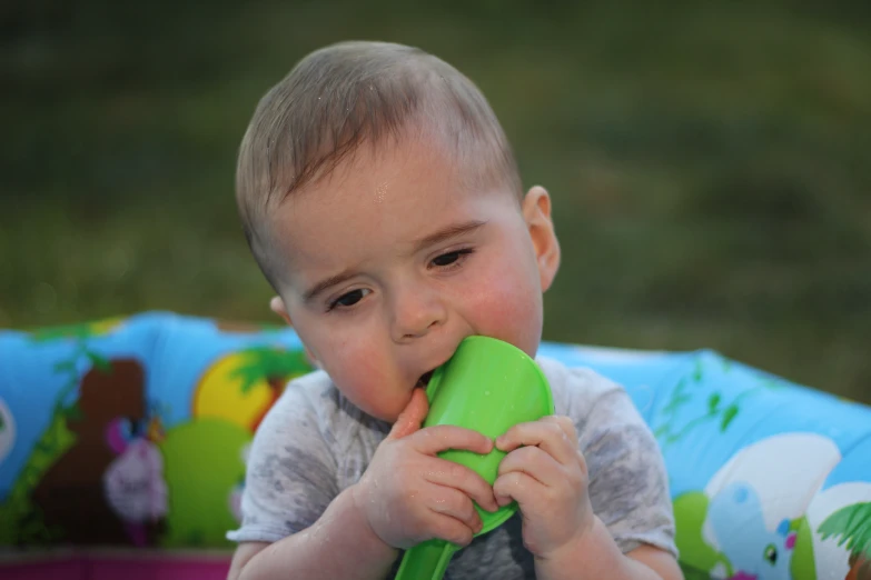 a small child eating soing in his mouth