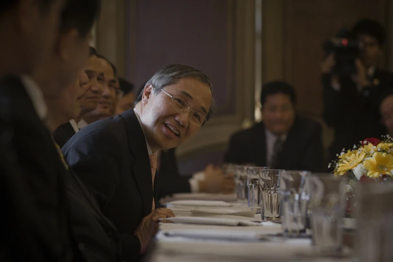 some people sitting at a table with wine glasses