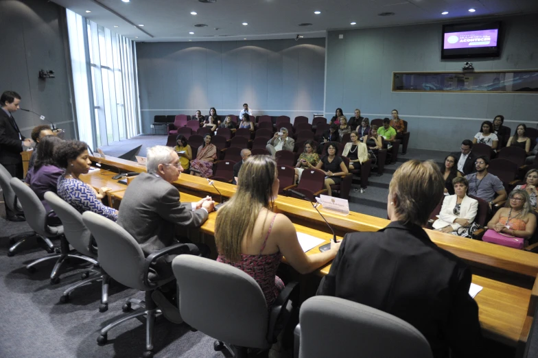 an audience watching a lecture in an auditorium