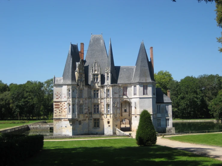 a large building with tall towers in front of trees