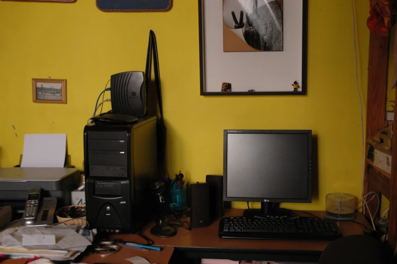 a desk top computer sitting on top of a wooden computer keyboard