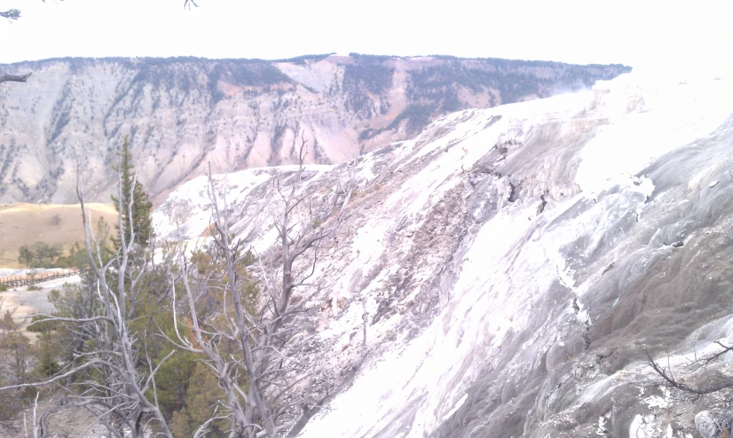 the mountains are covered in snow and trees