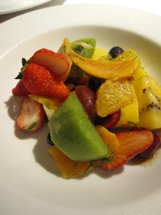 this is a po of fruit salad on a plate