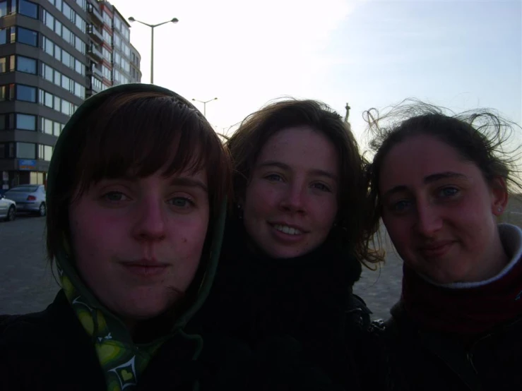 three young ladies who are posing for the camera