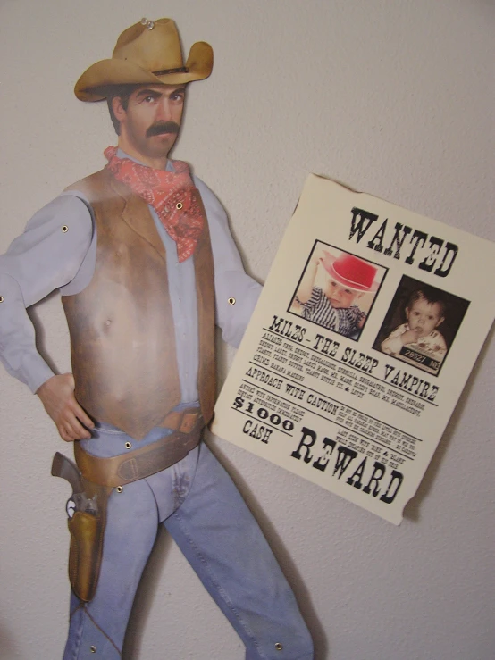 a cardboard figurine of a cowboy next to wanted poster