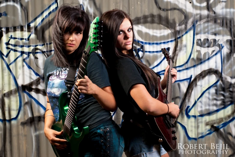 two young women are posing with guitars and posing for a po