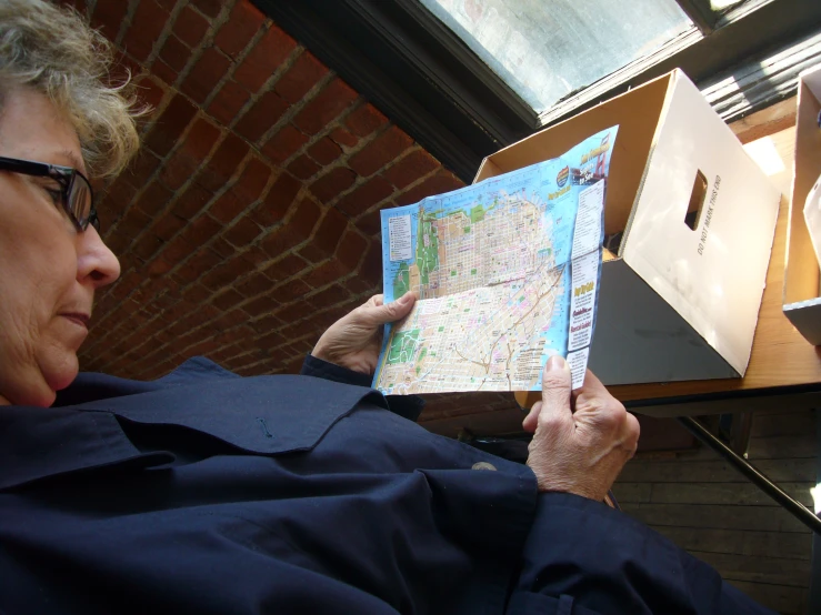 a woman holding up a map in her hands