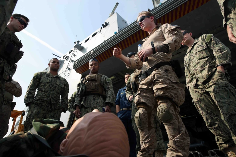 a group of soldiers talking and talking at an air port