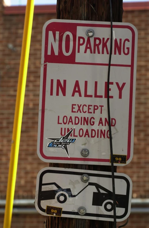 no parking signs posted on an electrical pole