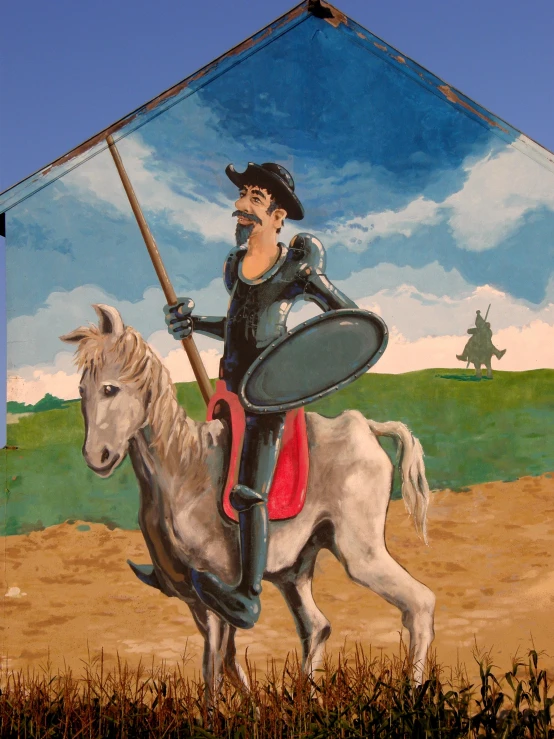 a mural painted on the side of a building depicts a man riding on a horse with a large shield in his hand