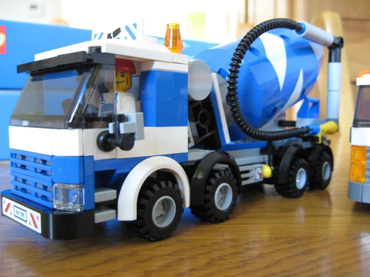 a toy truck with a cement mixer on the back