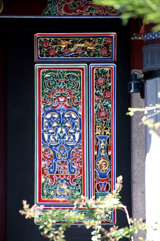 there is a red and blue door with decorative designs on it