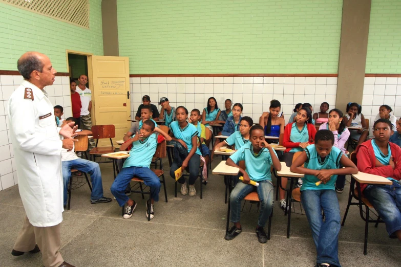 a man teaching an array of students in a classroom