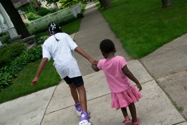 a father helping his small daughter hold hands