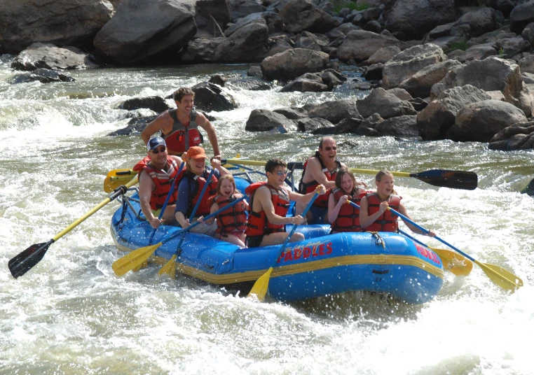 people in a raft going down the rapids