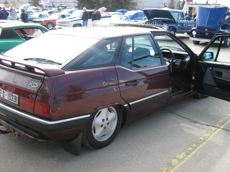 the car is parked on the street near other cars