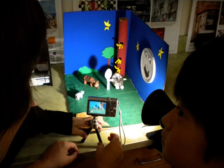 a little boy playing with a computer screen