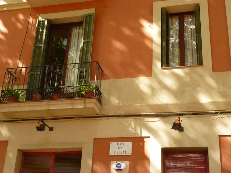 a very small apartment building with lots of windows