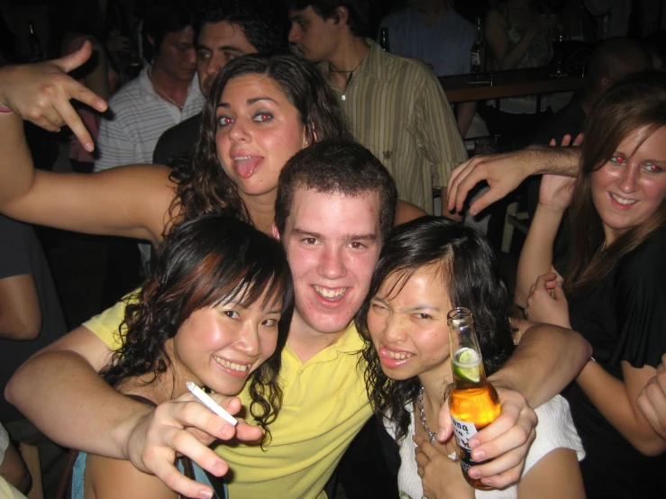 young adults in a bar posing for the camera