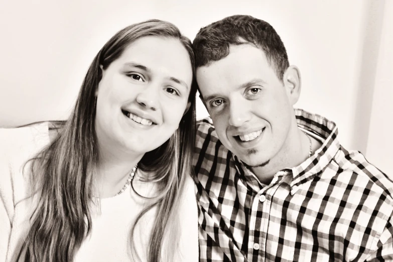 a smiling man and woman pose for a picture