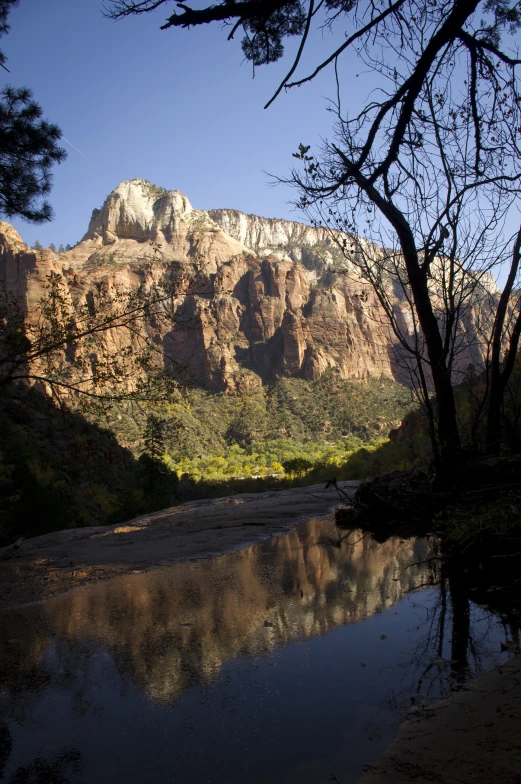 a river is near a big mountain and it has clear water